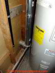Clothes dryer vent duct near electric water heater (C) Daniel Friedman