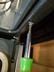 Removing the Jenn Air oven door retaining clip (C) Daniel Friedman at InspectApedia.com