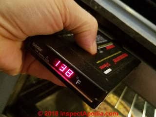 Measuring temperature around a Jenn-Air oven door after the glass front was broken away (C) Daniel Friedman at InspectApedia.com