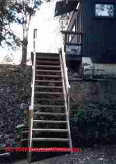 Exterior stair with 2x6 handrail on edge © D Friedman at InspectApedia.com 