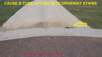 Poor surface and mixed red stains on concrete drive may be due to poor mix of additive during cold weather (C) InspectApedia.com Paul