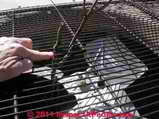 Photograph of  This new compressor was placed directly against
a brick wall. One third of its condenser coil cooling ability was blocked.