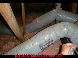 Photo of deteriorated fiberglass insulated gray covered Owens Corning gray flex duct (C) Daniel Friedman