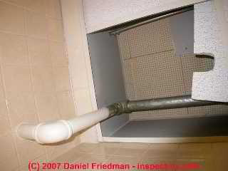 Photograph of lifted ceiling tile subverting air conditioning system air flow