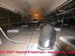 Photograph of commercial air conditioning system ceiling plenum with debris
