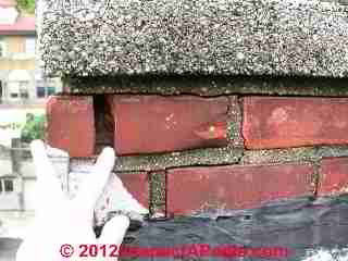 Frost cracked brick chimney viewed in attic (C) DanieL Friedman