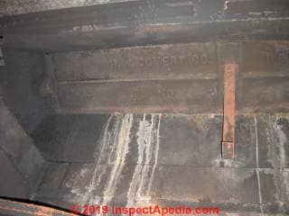 Rust and water stains at the fireplace damper tell us there are leaks above (C) Daniel Friedman at InspectApedia.com