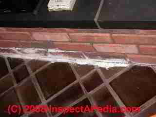 Fireplace settlement crack at floor (C) Daniel Friedman