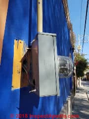 Electrical meter loose, pulling away from building (C) Daniel Friedman at InspectApedia.com