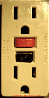 Red and black test & reset buttons on a GFCI receptacle (C) Daniel Friedman at InspectApedia.com