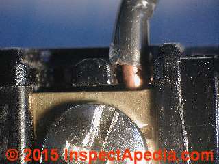 Clamp type electrical wire connector on a receptacle (C) Daniel Friedman