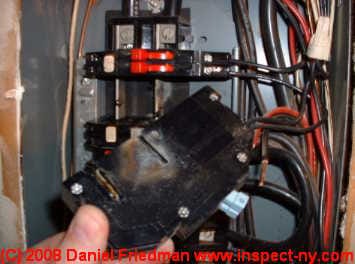 Characteristic deep notch in side of a Zinsco circuit breaker showing arc burns - this is an unsafe circuit breaker (C) Daniel Friedman at InspectApedia.com