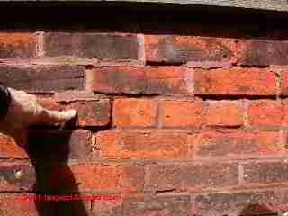 Brick wall tuck pointing bad job © Daniel Friedman at InspectApedia.com
