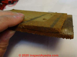 Brushed wood cedar shingle siding bonded to a fiberboard backer (C) InspectApedia.com SmallwoodK
