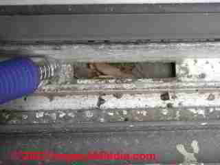 Metal slider window drain opening clog (C) D Friedman