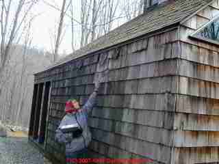 Photograph of leaky wood shingles on a home exterior.