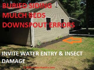 Vinyl siding buried in a mulch bed is an insect damage risk and the bed a water entry risk (C) InspectApedia.com Dovber Kahn 2018