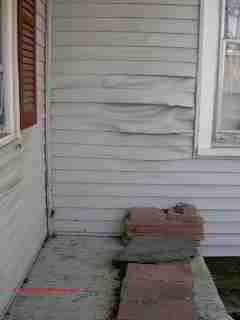 Photograph of - damaged vinyl siding