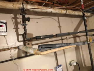 1980s townhome fiberglass pipe insulation (C) InspectApedia.com Gabriel