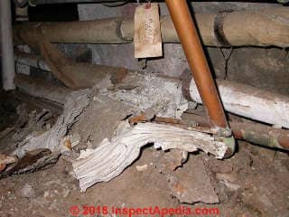 Asbestos debris on basement or crawl space floor, falling off of pipes (C) Daniel Friedman