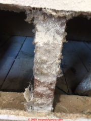 Asbestos pipe insulation in poor condition (C) InspectApedia.com Roxanne