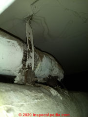 Asbestos pipe insulation (C) InspectApedia.com Mark