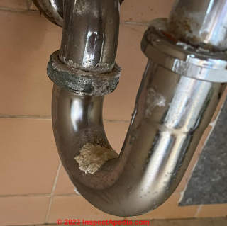 corroded leaky trap not asbestos (C) InspectApedia.com Lynne