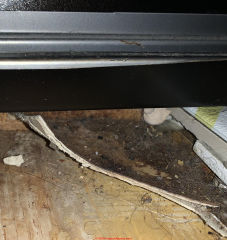 asbestos suspect flooring under oven (C) InspectApedia.com Rollings