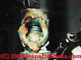 Leaky relief valve showing corrosion and debris
