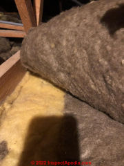 Yellow & gray fibrous insulation - fiberglass ? (C) InspecApedia.com Rich