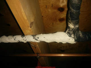 Sticky insulating pipe wrap, some may contain asbestos (C) InspectApedia.com Steve