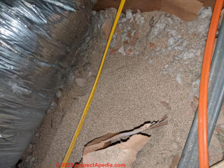 Brown granular insulation resembling "termite poop" - (C) InspectApedia.com Robb