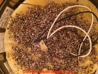 Vermiculite insulation in a ceiling-mounted light fixture (C) InspectApedia.com SE