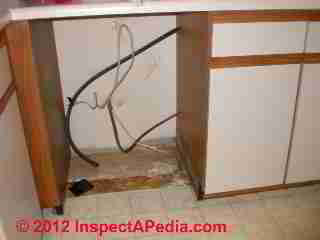 Cabinet water damage from dishwasher © D Friedman at InspectApedia.com 