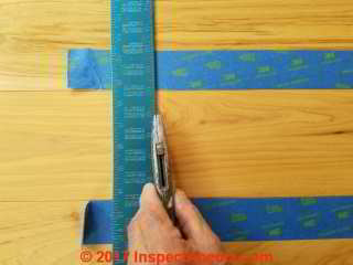 Scoring the wood flooring cut line before using a saw avoids splinters (C) Daniel Friedman