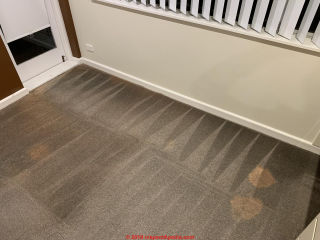 Regular marks on carpet are traced to a mechanical operation or to exposure of light in a pattern (C) InspectApedia.com