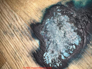 Smoke pellet damage to laminate flooring (C) InspectApedia.com Brenda