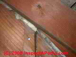 UFFI foam insulation visible in a gap between building sheathing boards (C) Daniel Friedman