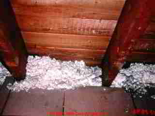 soffit blocked by mineral wool - note ice dam leak stains