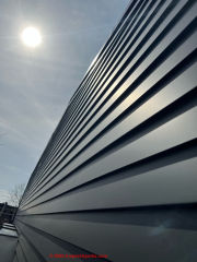 Noisy metal siding on sun-exposed side of a new home (C) InspectApedia.com  Ammendolia