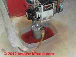 Oil filter change at heating boiler or furnace (C) D Friedman