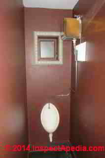 Wall cistern opeated urinal installed in a toilet in Akaroa, Canterbury, New Zealand (C) Daniel Friedman