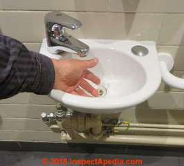 Space saving tiny lav sink in a bath in Monmouth Wales UK (C) Daniel Friedman InspectApedia.com