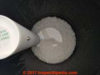 Salt covered by water in a Pentair Fleck water softener during installation in San Miguel de Allende (C) Daniel Friedman