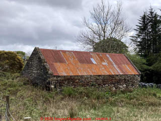 Corrugated steel roof (rusty) on an antique stone building in Scotland (C) InspectApedia.com Chloe Church