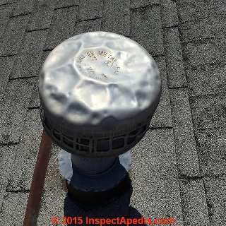 Hail damaged metal roof vent cap (C) InspectApedia.com & Russell Frazier 