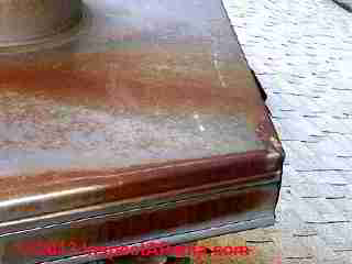Red roof stains traced to chimney top flashing and collar rust (C) Inspectapedia