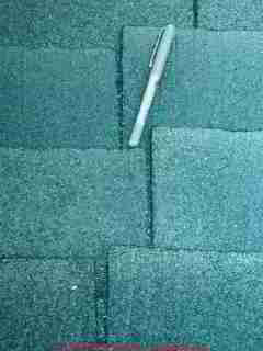 Photograph of strip type asphalt roof shingles poorly installed in a ladder pattern