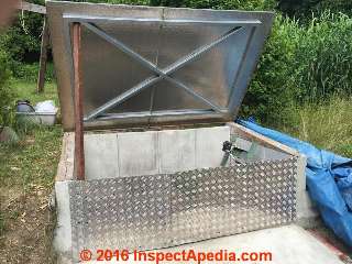 Access cover for concrete septic tank converted to underground storage room (C) InspectApedia.com KH
