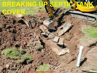 Breaking up concrete septic tank cover during tank abandonment (C) InspectApedia.com A Church